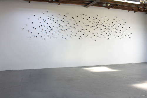 Toward, 2012. White pencil, acrylic, porcelain. Variable dimension. 230 portraits, 2x2x3 in  -  5x5x7 cm each.